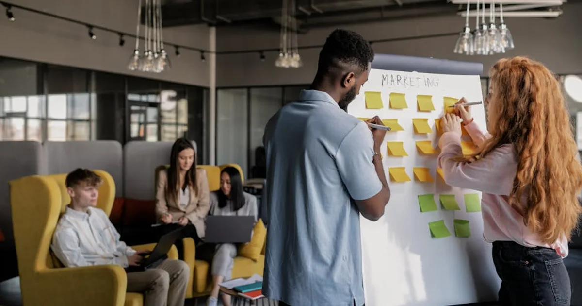 marketing team office whiteboard planning, illustrating How AI is Changing Digital Marketing in 2026: Why Influence Beats Traffic